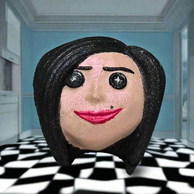 Topher’s Beard and Soap Co. Other Mother Bath Bomb – hand-painted Coraline-inspired bath bomb styled with a blue wall background and black and white checkerboard floor, capturing the eerie and surreal atmosphere of the Other World.