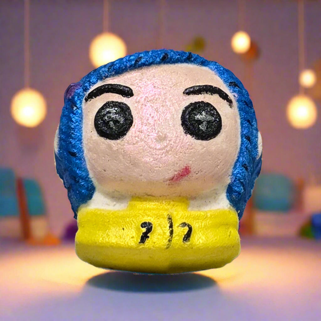 Topher’s Beard and Soap Co. Other Caroline Bath Bomb – hand-painted Coraline-inspired bath bomb displayed on a pastel background with soft hanging lights, styled to reflect the eerie charm and whimsical tone of the Other World.