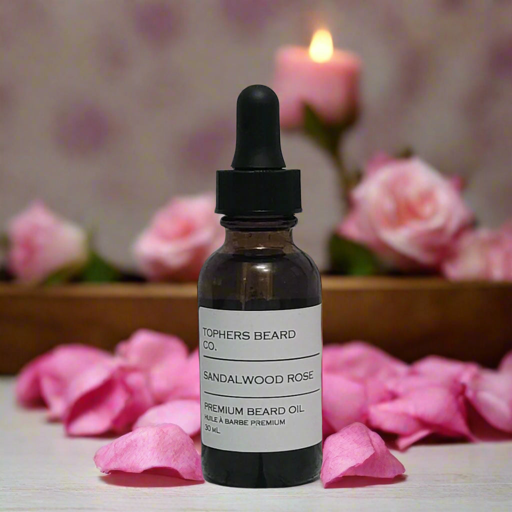 Topher's Beard and Soap Co. Sandalwood Rose Beard Oil – 30 ml dropper bottle with clean minimalist label, surrounded by rose petals and soft pink candlelight ambiance