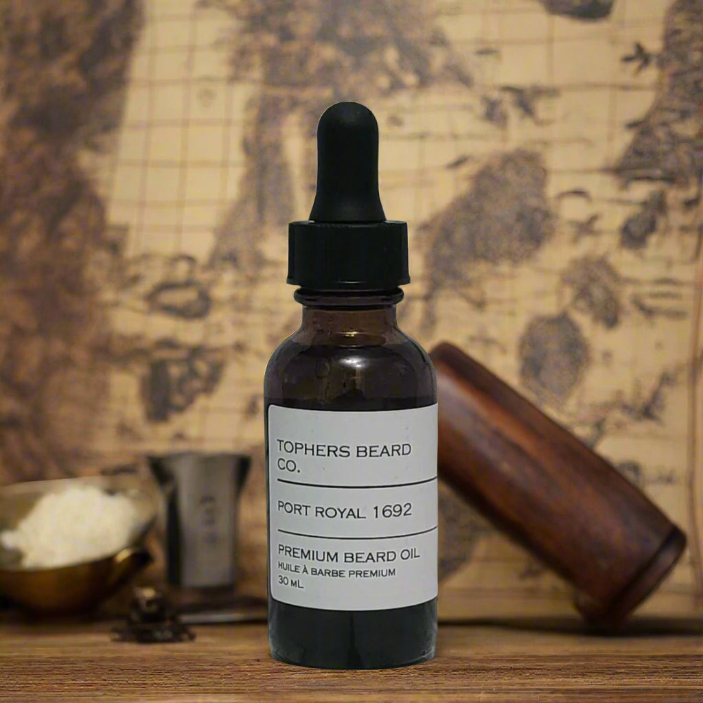 Topher's Beard and Soap Co. Port Royal 1692 Beard Oil – 30 ml amber bottle with minimalist label, set against a vintage pirate map with grooming tools for a rugged, nautical vibe