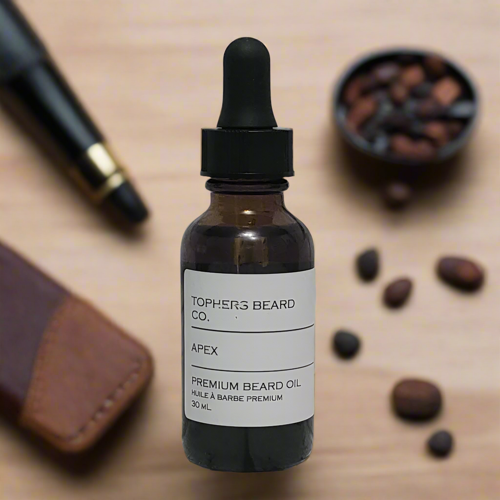Topher's Beard and Soap Co. Apex Premium Beard Oil – 30 ml amber dropper bottle with sleek label, styled on wood with coffee beans, cigar, and leather for a rich, masculine vibe