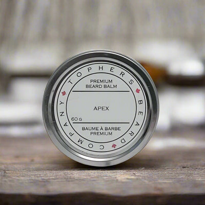 Topher's Beard and Soap Co. Apex Beard Balm – 60 g tin with clean, minimalist label, displayed on rustic wood with soft background for a bold and refined grooming vibe

