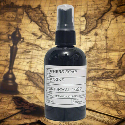 Topher's Beard and Soap Co. Port Royal 1692 Cologne – 126 ml black bottle with minimalist label featuring notes of tobacco, teakwood, spice, and tonka, styled against an antique nautical map for a bold, adventurous vibe