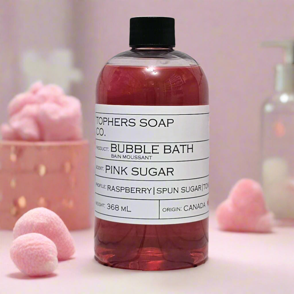 Topher's Beard and Soap Co. Pink Sugar Bubble Bath – 368 ml bottle of sweet pink bubble bath with notes of raspberry and spun sugar, styled with soft cotton candy-inspired decor on a pastel pink background