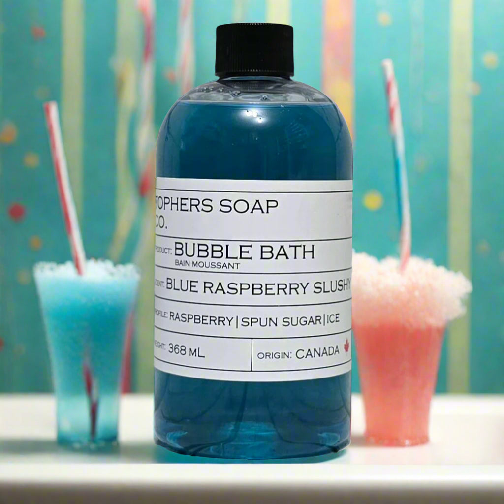 Topher's Beard and Soap Co. Blue Raspberry Slushy Bubble Bath – 368 ml bottle of vibrant blue bubble bath with raspberry, spun sugar, and ice scent notes, styled alongside icy blue and pink slush drinks with striped straws