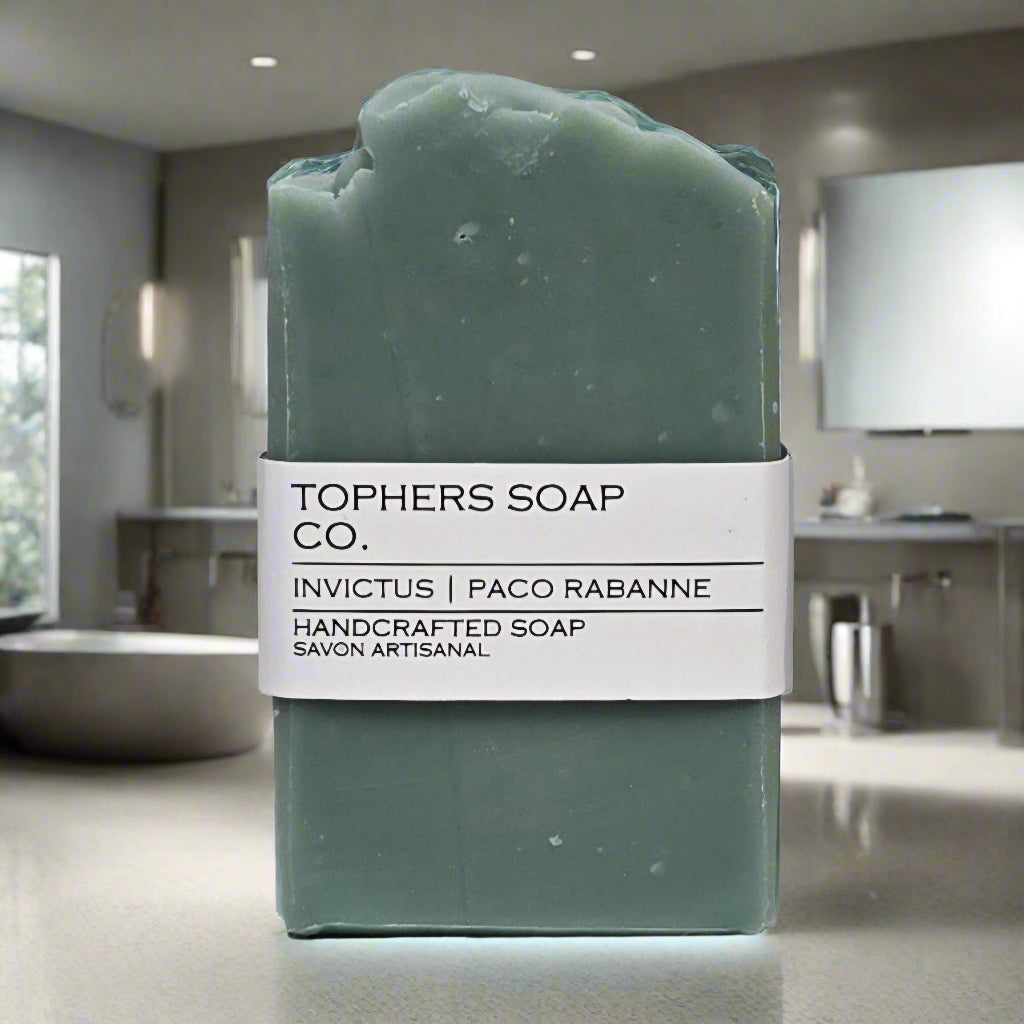 Topher's Beard and Soap Co. Invictus | Paco Rabanne Handcrafted Soap – solid teal soap bar with minimalist label, displayed in a sleek modern bathroom setting for a clean, masculine vibe