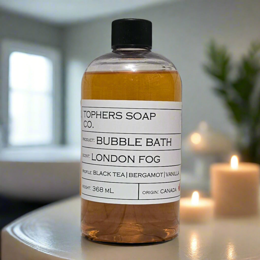 Topher's Beard and Soap Co. London Fog Bubble Bath – 368 ml amber-toned bubble bath scented with black tea, bergamot, and vanilla, displayed in a calm, candlelit setting with soft neutral tones