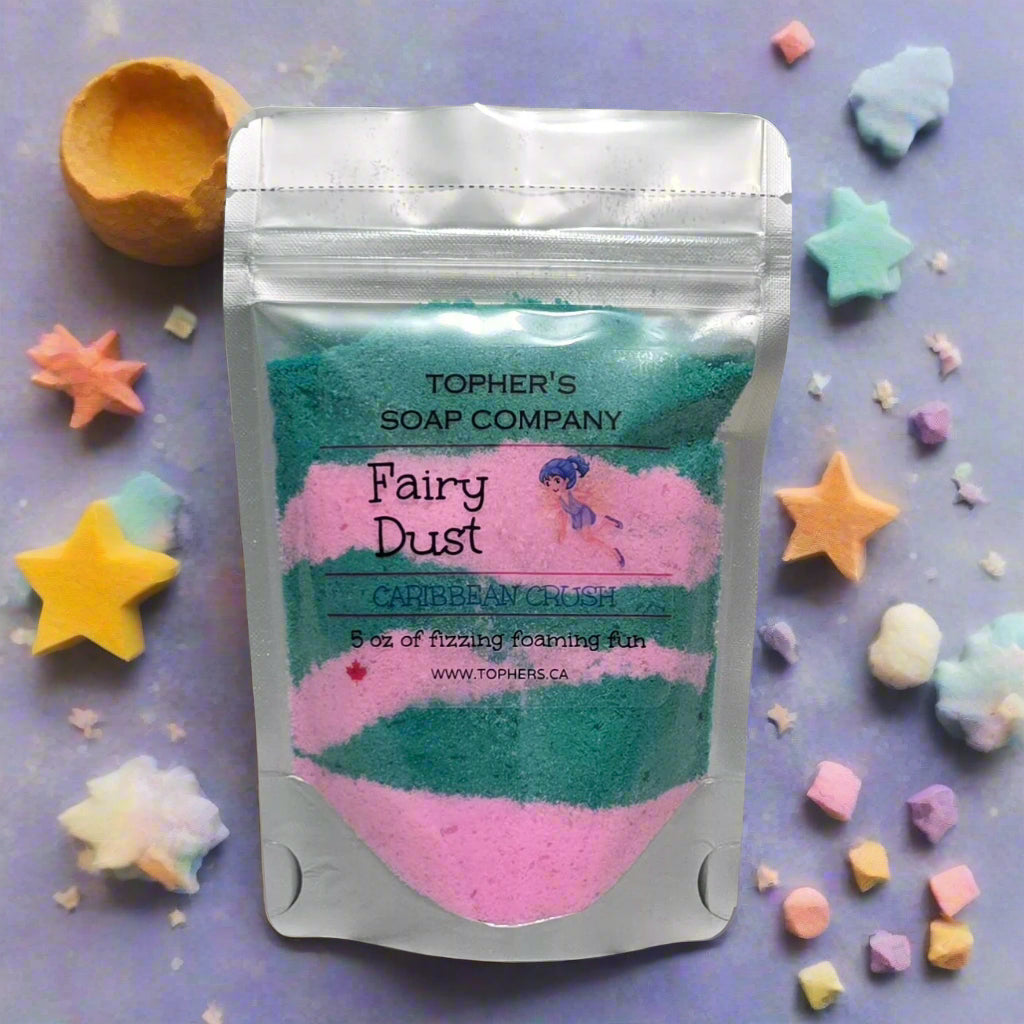 Resealable pouch of Tophers Soap Co. Fairy Dust foaming bath bomb powder in the Caribbean Crush scent, a mix of teal and pink powder, surrounded by colorful star and cloud-shaped bath bombs, showcasing a fun bath experience made in Brantford, Ontario.