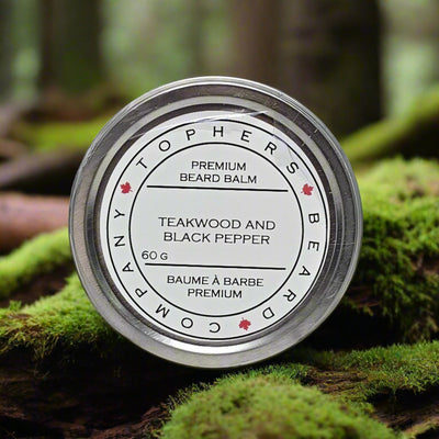 Topher's Beard and Soap Co Echo Grove Premium Beard Balm (60 g) tin resting on vibrant green moss in a peaceful forest setting, evoking a rich, woodsy scent experience.