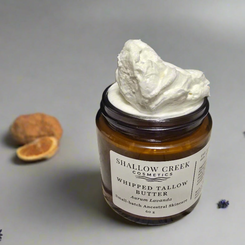 Close-up of Shallow Creek Cosmetics Whipped Tallow Butter, Aurum Lavanda, showing its rich, whipped, and airy texture mounding high above the jar's rim, indicating a freshly opened or generously filled product.