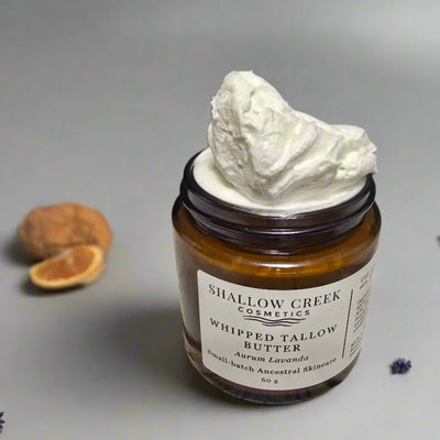 Close-up of Shallow Creek Cosmetics Whipped Tallow Butter, Aurum Lavanda, showing its rich, whipped, and airy texture mounding high above the jar's rim, indicating a freshly opened or generously filled product.