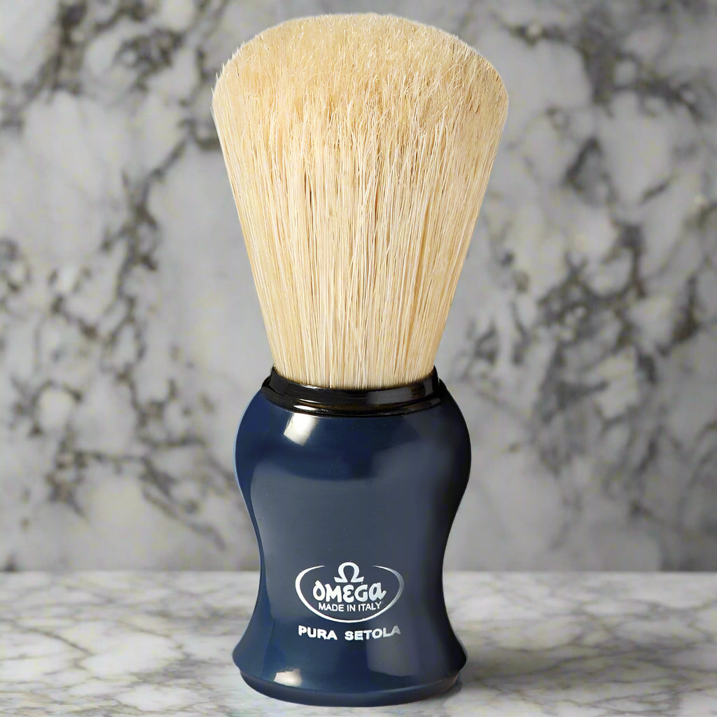 Topher's Beard and Soap Co. Omega Pura Setola Shaving Brush – classic Italian-made boar bristle brush with bright blue ergonomic handle, displayed on a marble background