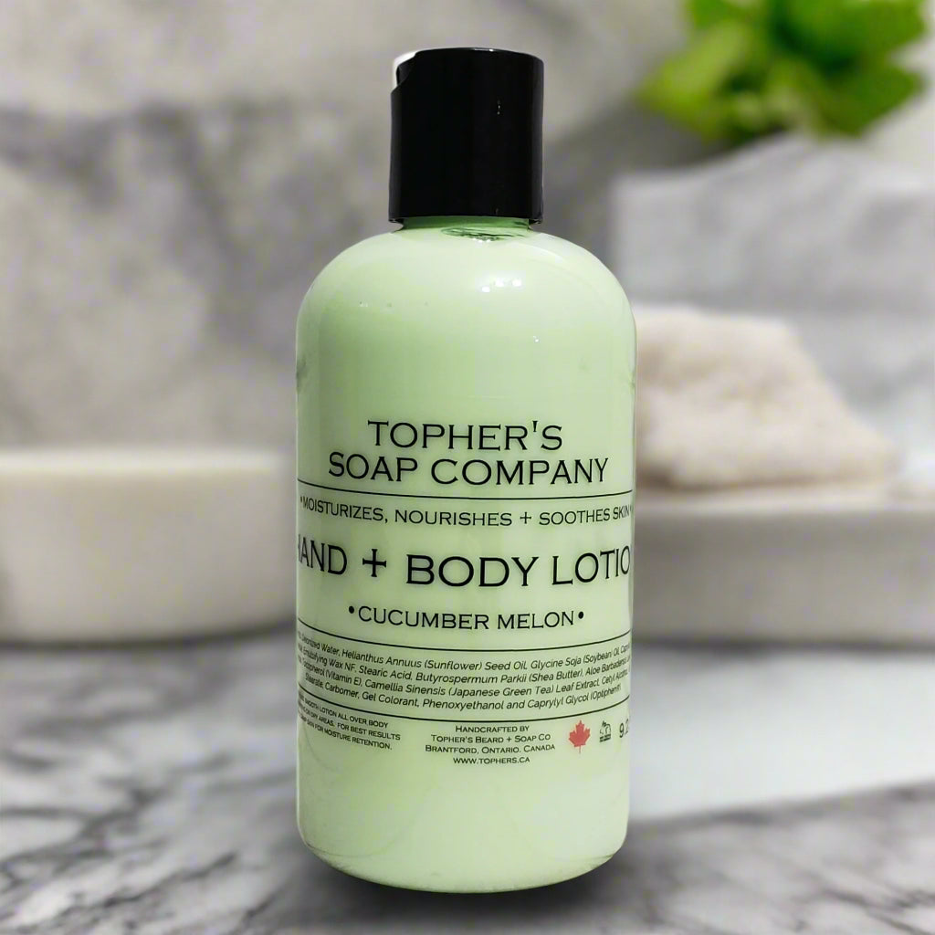 Light green bottle of Tophers Soap Co. Cucumber Melon Hand & Body Lotion with a black pump, featuring a label that highlights the "crisp cucumber & sweet melon" scent, photographed on a marble surface, indicating a refreshing and naturally-formulated lotion handcrafted in Brantford, Ontario, Canada.