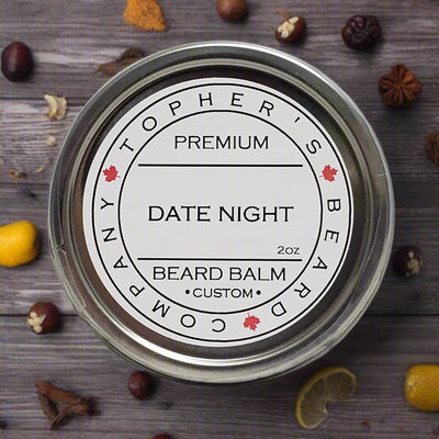 Top-down view of a silver tin of Tophers Beard Co. Date Night Premium Beard Balm, featuring a label with the product name and the Canadian maple leaf, surrounded by suggestive elements like citrus and spices on a rustic wooden background, indicating a locally handcrafted product from Brantford, Ontario.