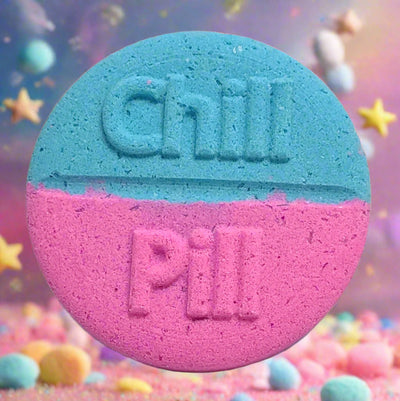 Tophers Soap Co. Unicorn Chill Pill Bath Bomb, a large round bath bomb split in light blue and pink with "Chill Pill" embossed on it, surrounded by pastel candies and stars, evoking a magical candy and bubblegum scent, handcrafted in Brantford, Ontario, Canada.