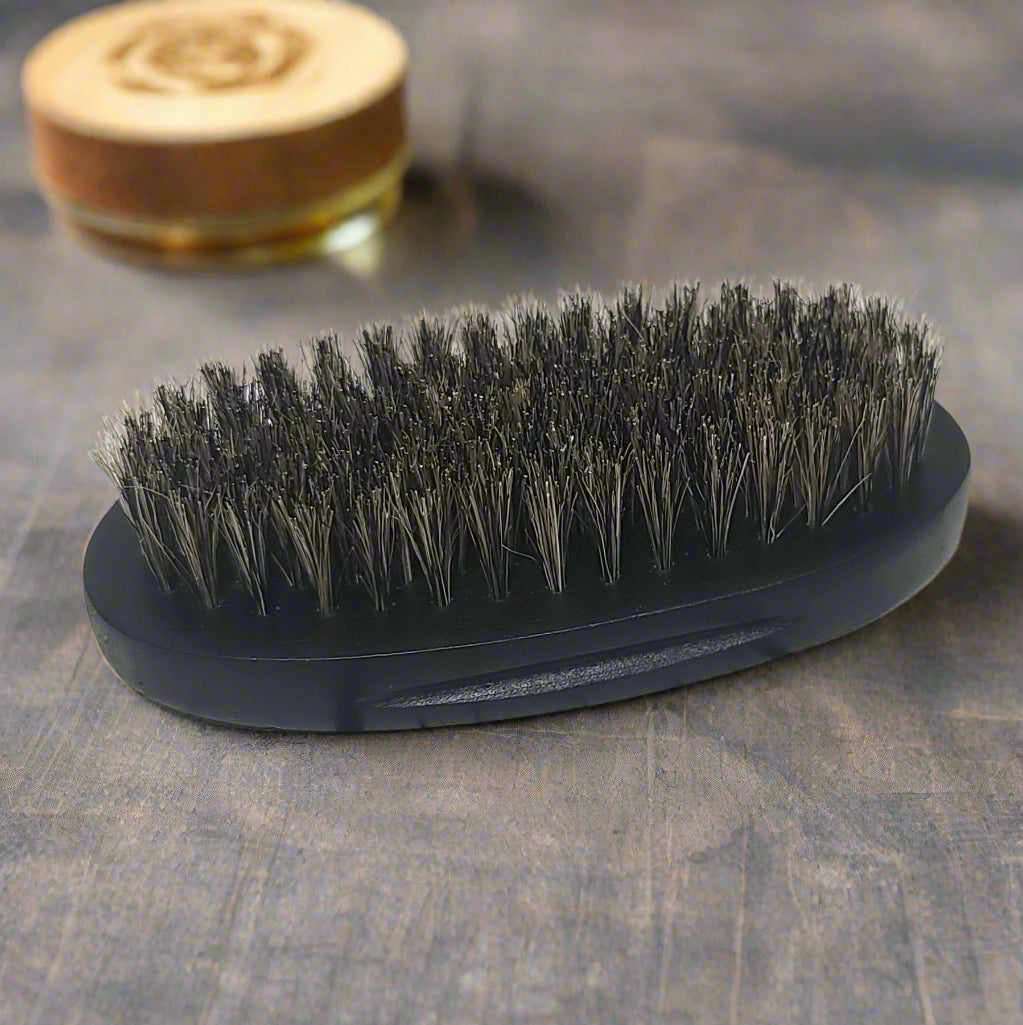 Close-up of the black, oval Boar Hair Brush from Tophers Beard Co., showcasing its dense blend of natural boar and synthetic bristles, available in Brantford, Ontario.