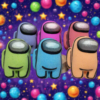 A collection of six colorful bath bombs shaped like crewmates from the video game Among Us, in shades of light green, blue, pink, purple, red, and peach, each with black outlining and a silver visor, against a dark cosmic background with colorful orbs and stars, from Tophers Soap Co. in Brantford, Ontario.