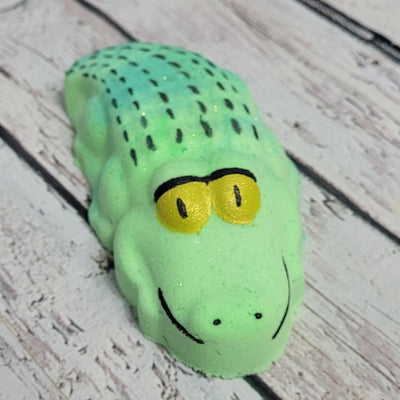 Hand painted alligator bath bomb on white washed table | Tophers Beard and Soap Company