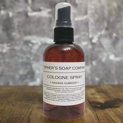 Dark bottle of Tophers Beard Co. Havana Humidor Cologne Spray with a clear spray nozzle and a white label detailing its rich, cigar-inspired scent, likely photographed in Brantford, Ontario, Canada, where it is crafted by Tophers Soap Company.