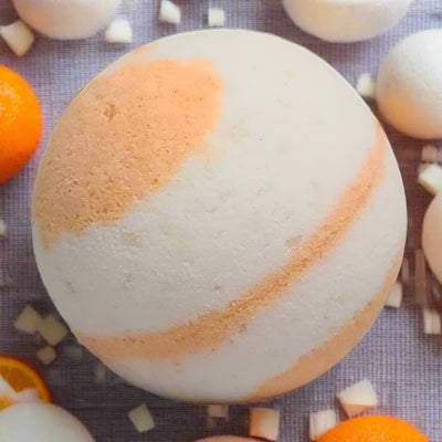 Orange and white swirl bath bomb, suggestive of an orange vanilla creamsicle scent. Tophers Soap Co.