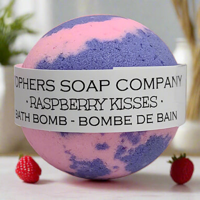 A luscious Raspberry Kisses bath bomb, promising a bright and sweet berry-scented soak with colorful bath art. Handcrafted in Brantford, Ontario.